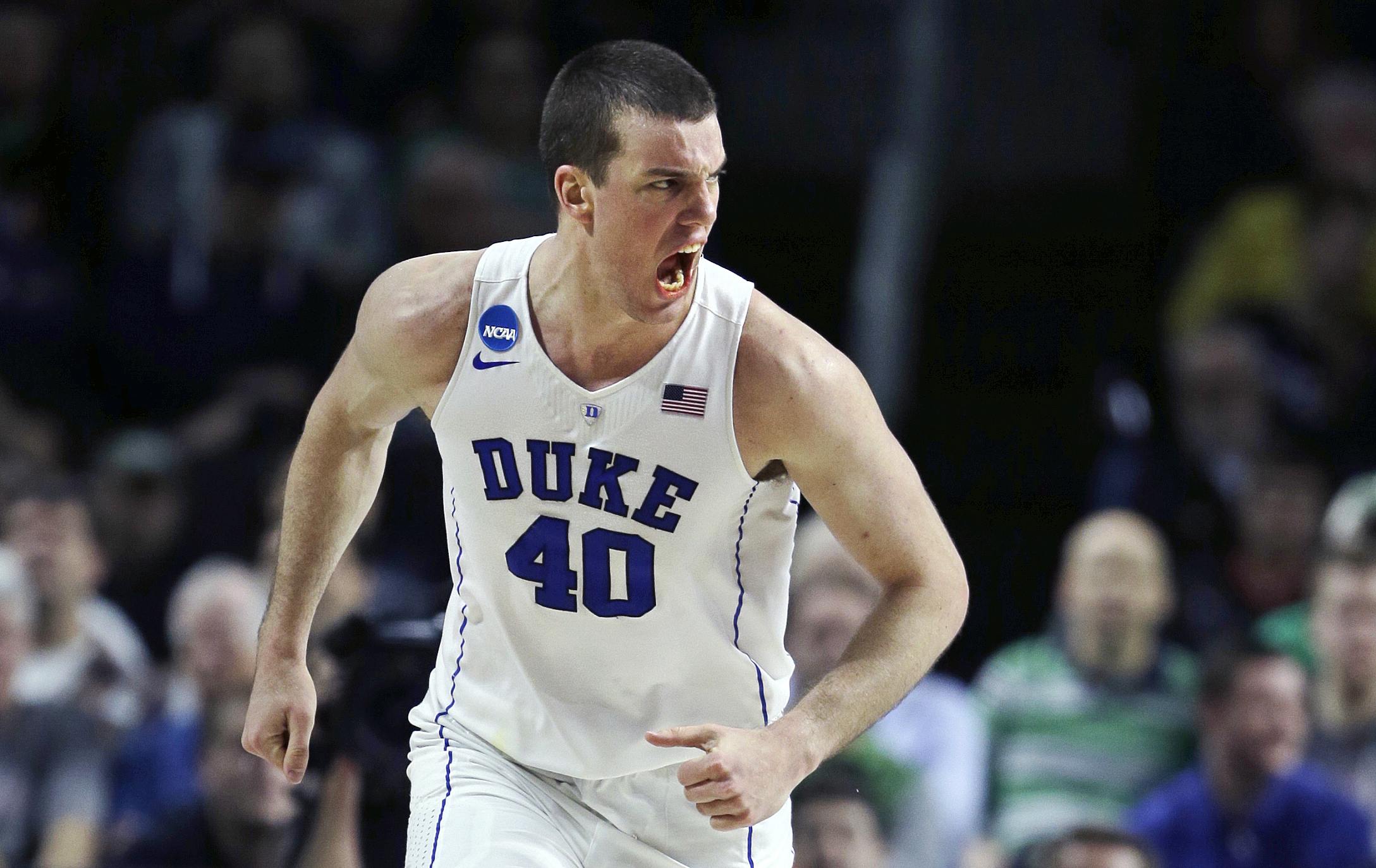 Duke center Marshall Plumlee (40) lets out a yell towards his bench as he heads up court after a basket against North Carolina-Wilmington in the second half during the first round of the NCAA college men's basketball tournament in Providence, R.I., Thursday, March 17, 2016. Plumlee had 23 points as Duke defeated North Carolina-Wilmington 93-85. (AP Photo/Charles Krupa)