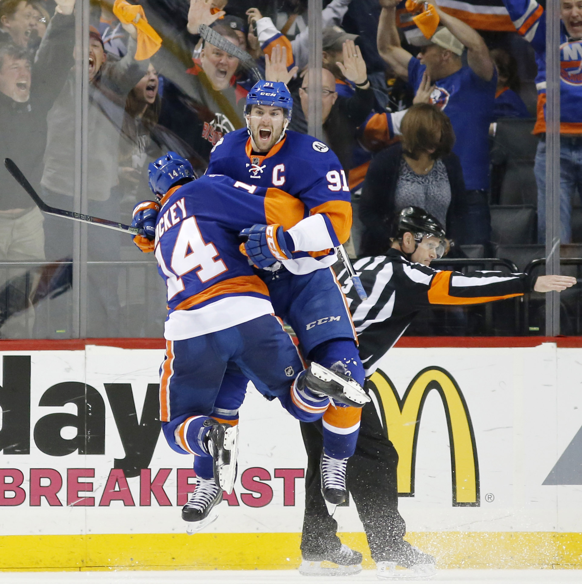 New York Islanders defenseman Thomas Hickey (14) leaps in the air with New York Islanders center John Tavares (91) after Tavares scored the winning goal in the second overtime period of Game 6 of an NHL hockey first-round Stanley Cup playoff series against the Florida Panthers in New York, Sunday, April 24, 2016. The Islanders defeated the 2-1. (AP Photo/Kathy Willens)