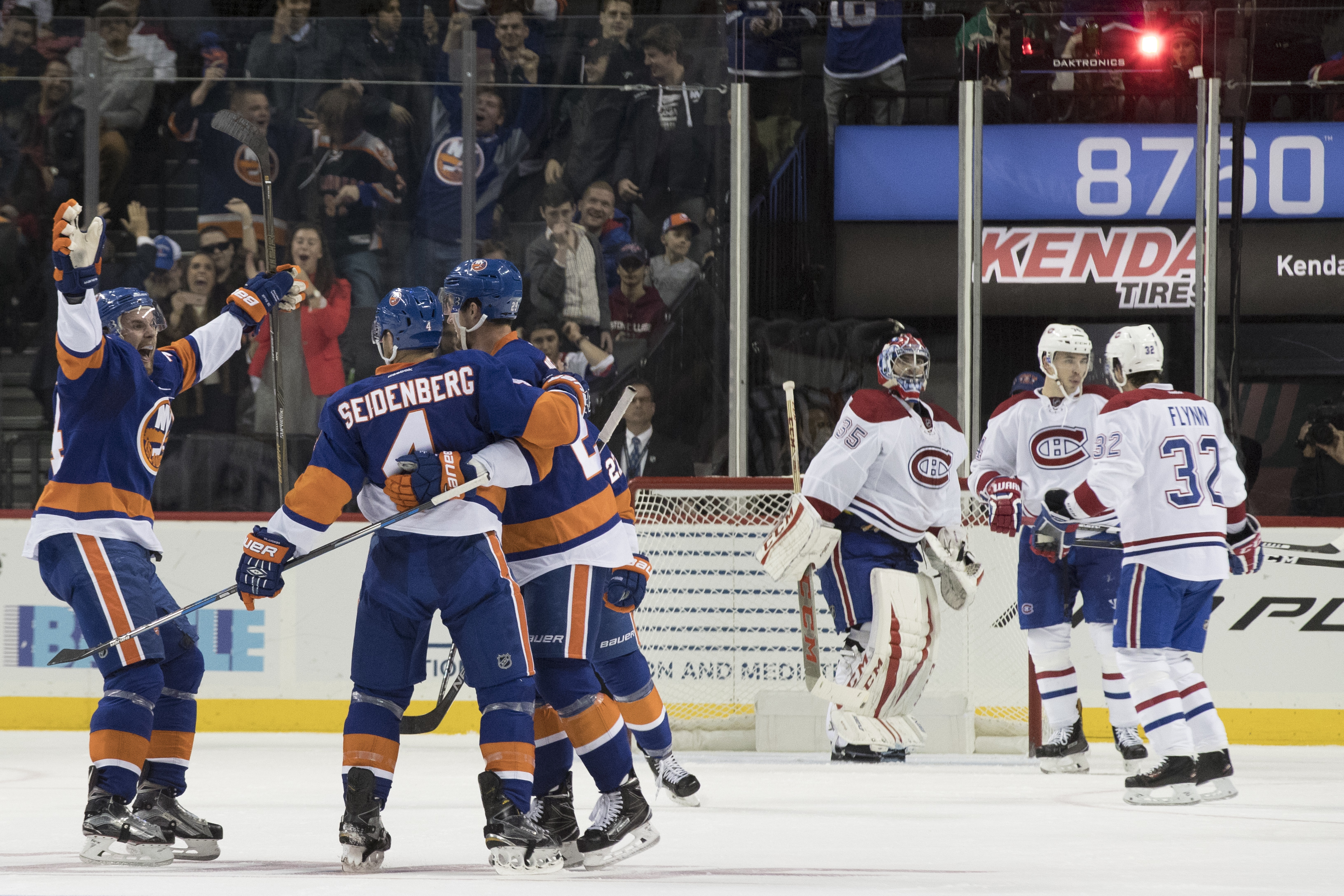 New York Islanders defenseman Dennis Seidenberg (4) celebrates with his teammates after scoring a goal during the third period of an NHL hockey game against the Montreal Canadiens, Wednesday, Oct. 26, 2016 in New York. The Canadiens won 3-2. (AP Photo/Mary Altaffer)