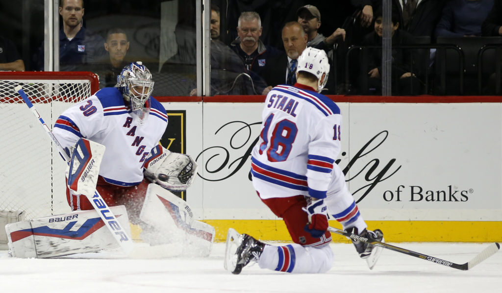 New York Rangers defenseman Mark Staal (28) defends as Rangers goalie Henrik Lundqvist (30) of Sweden makes a save in the first period of an NHL hockey game at the Barclays Center in New York, Wednesday, Dec. 2, 2015. (AP Photo/Kathy Willens)