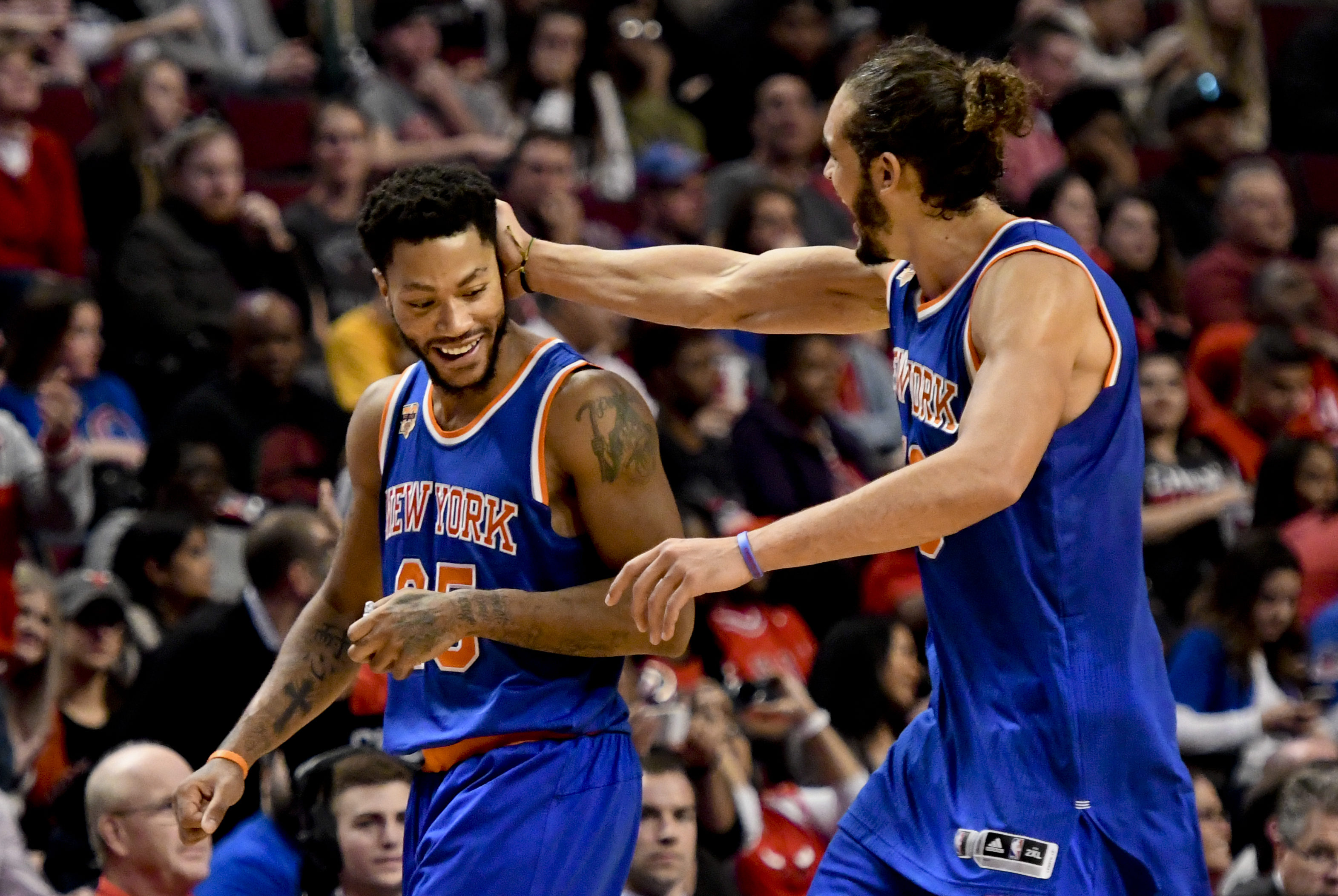 New York Knicks guard Derrick Rose (25) and New York Knicks center Joakim Noah (13) high-five in the fourth quarter of an NBA basketball game against the Chicago Bulls Friday, Nov. 4, 2016, in Chicago. The New York Knicks beat the Chicago Bulls 117-104. (AP Photo/Matt Marton)
