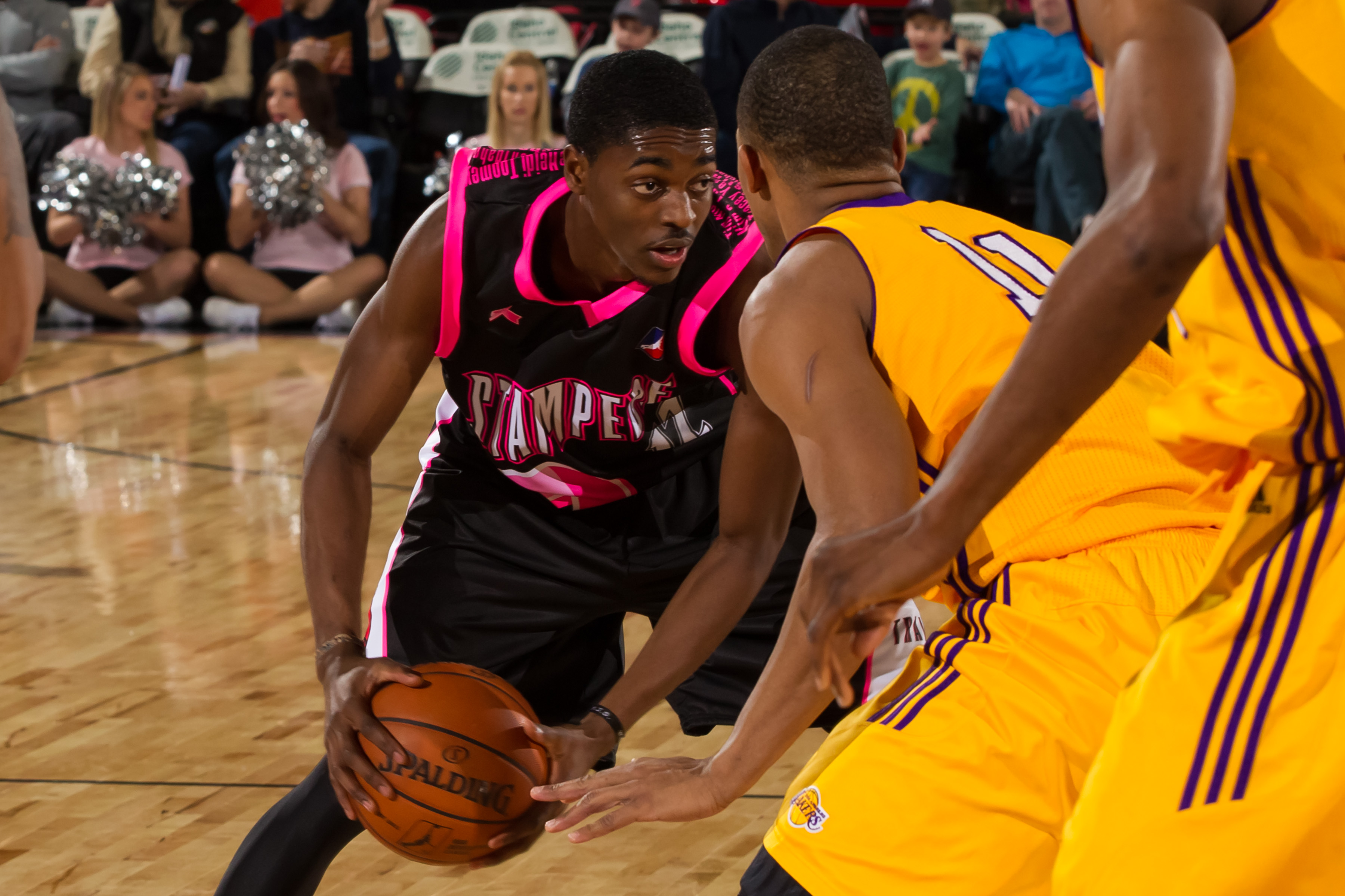 BOISE, ID - FEBRUARY 1: Justin Holiday #12 of the Idaho Stampede looks for a pass around the Los Angeles D-Fenders during the NBA D-League game on February 1, 2013 at CenturyLink Arena in Boise, Idaho. The Stampede wore pink jerseys for a mammography assistance fundraiser. NOTE TO USER: User expressly acknowledges and agrees that, by downloading and/or using this Photograph, user is consenting to the terms and conditions of the Getty Images License Agreement. Mandatory Copyright Notice: Copyright 2013 NBAE (Photo by Otto Kitsinger/NBAE via Getty Images)