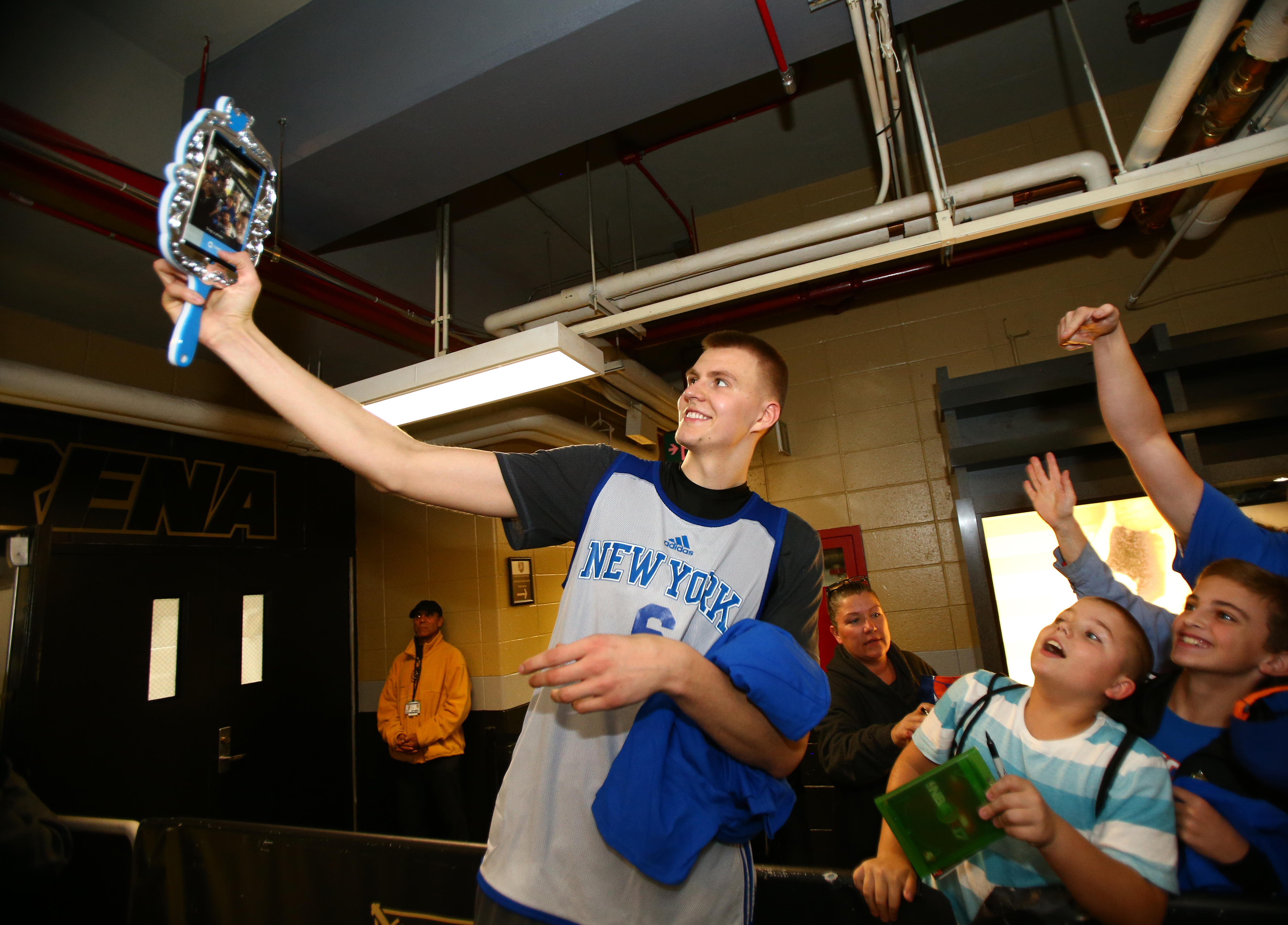 WEST POINT, NY - SEPTEMBER 30: Kristaps Porzingis #6 of the New York Knicks takes a picture with some fans during training camp practice on September 30, 2016 at The U.S. Military Academy at West Point in West Point, New York. NOTE TO USER: User expressly acknowledges and agrees that, by downloading and or using this Photograph, user is consenting to the terms and conditions of the Getty Images License Agreement. Mandatory Copyright Notice: Copyright 2016 NBAE (Photo by Nathaniel S. Butler/NBAE via Getty Images)