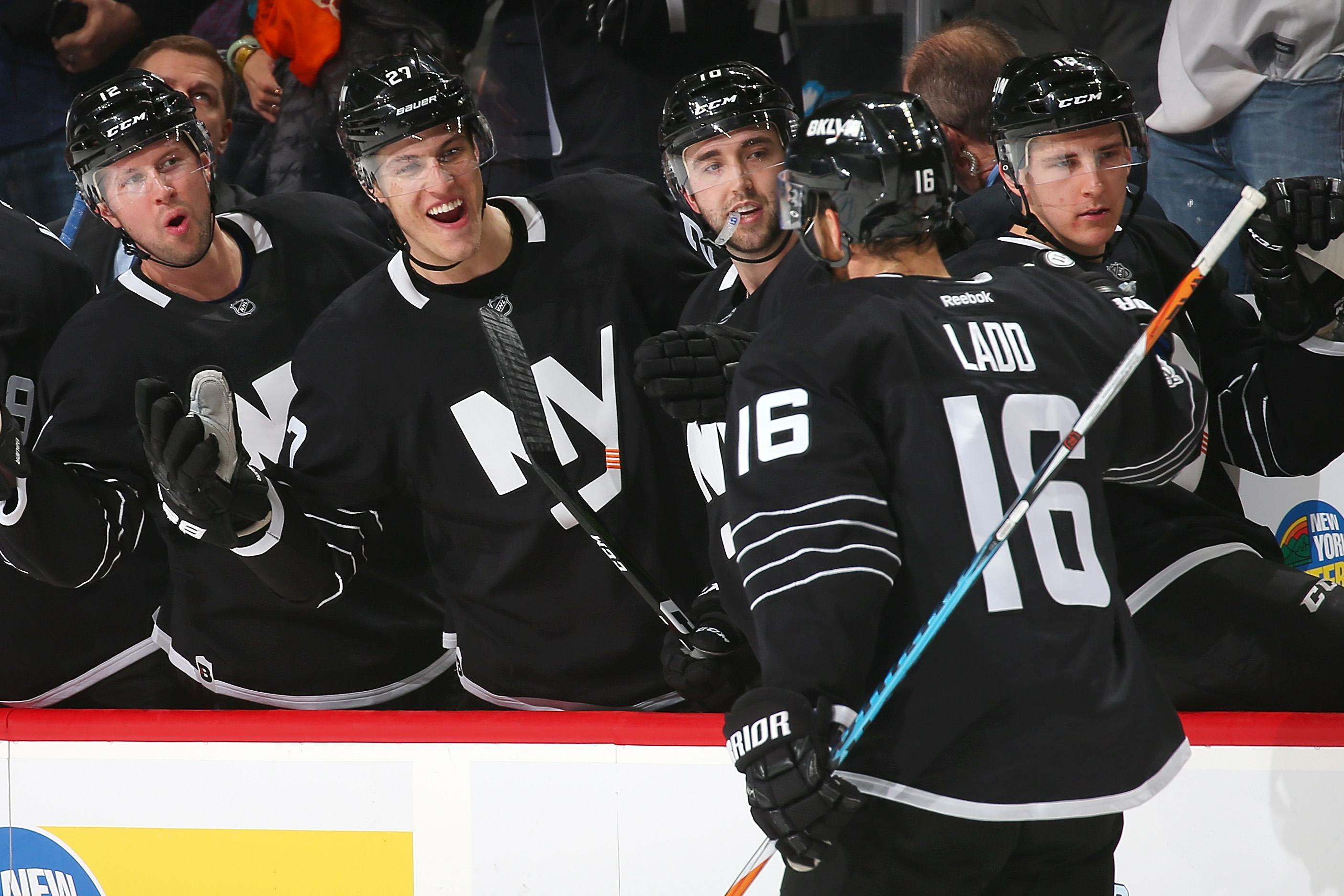 NEW YORK, NY - JANUARY 26: Andrew Ladd #16 of the New York Islanders celebrates his third period goal against the Montreal Canadiens with teammates at the Barclays Center on January 26, 2017 in Brooklyn borough of New York City. (Photo by Mike Stobe/NHLI via Getty Images)