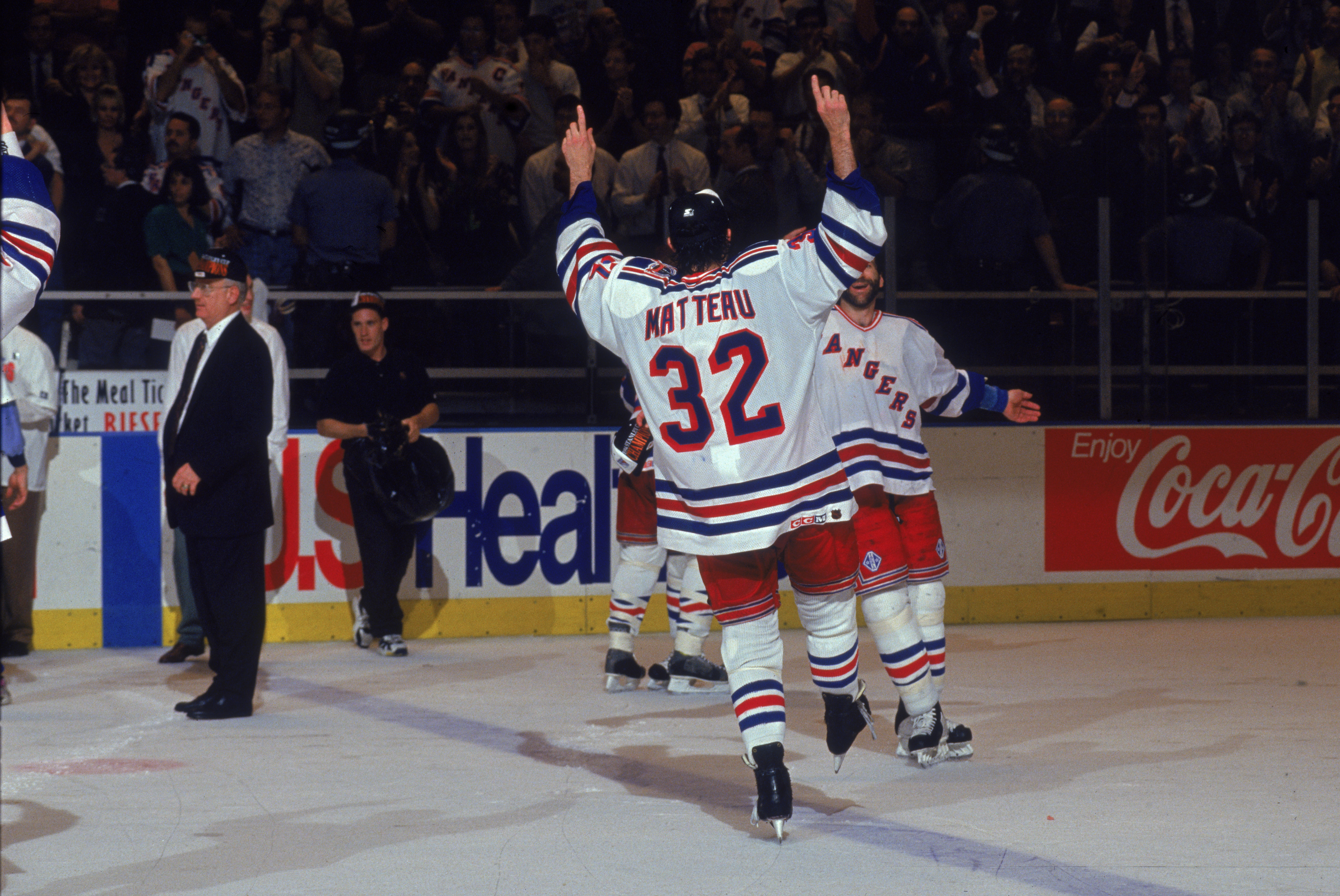 Canadian professional ice hockey player Stephane Matteau #32 of the New York Rangers skates on the ice in celebration toward bearded teammate Glenn Anderson after winning the Stanley Cup Championship, Madison Square Garden, New York, June 14, 1994. Stephane Matteau played for the New York Rangers from 1993 to 1996. (Photo by Bruce Bennett Studios/Getty Images)