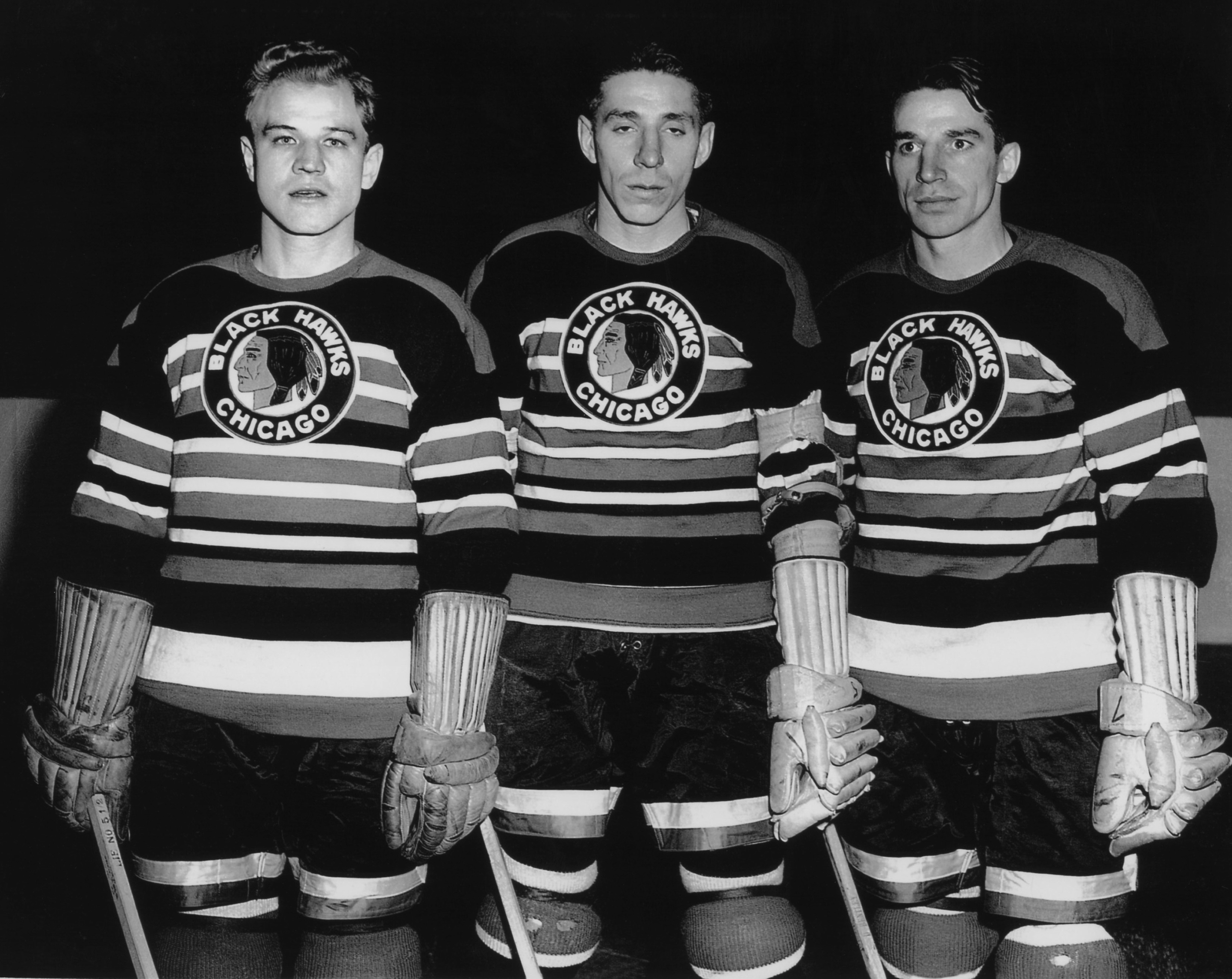 CHICAGO, IL - 1946: Bill Mosienko #8, Max Bentley #5 and Doug Bentley #7 pose for a portrait before an NHL game circa 1946 at Chicago Stadium in Chicago, Illinois. The three players formed the Pony Line. (Photo by B Bennett/Getty Images)