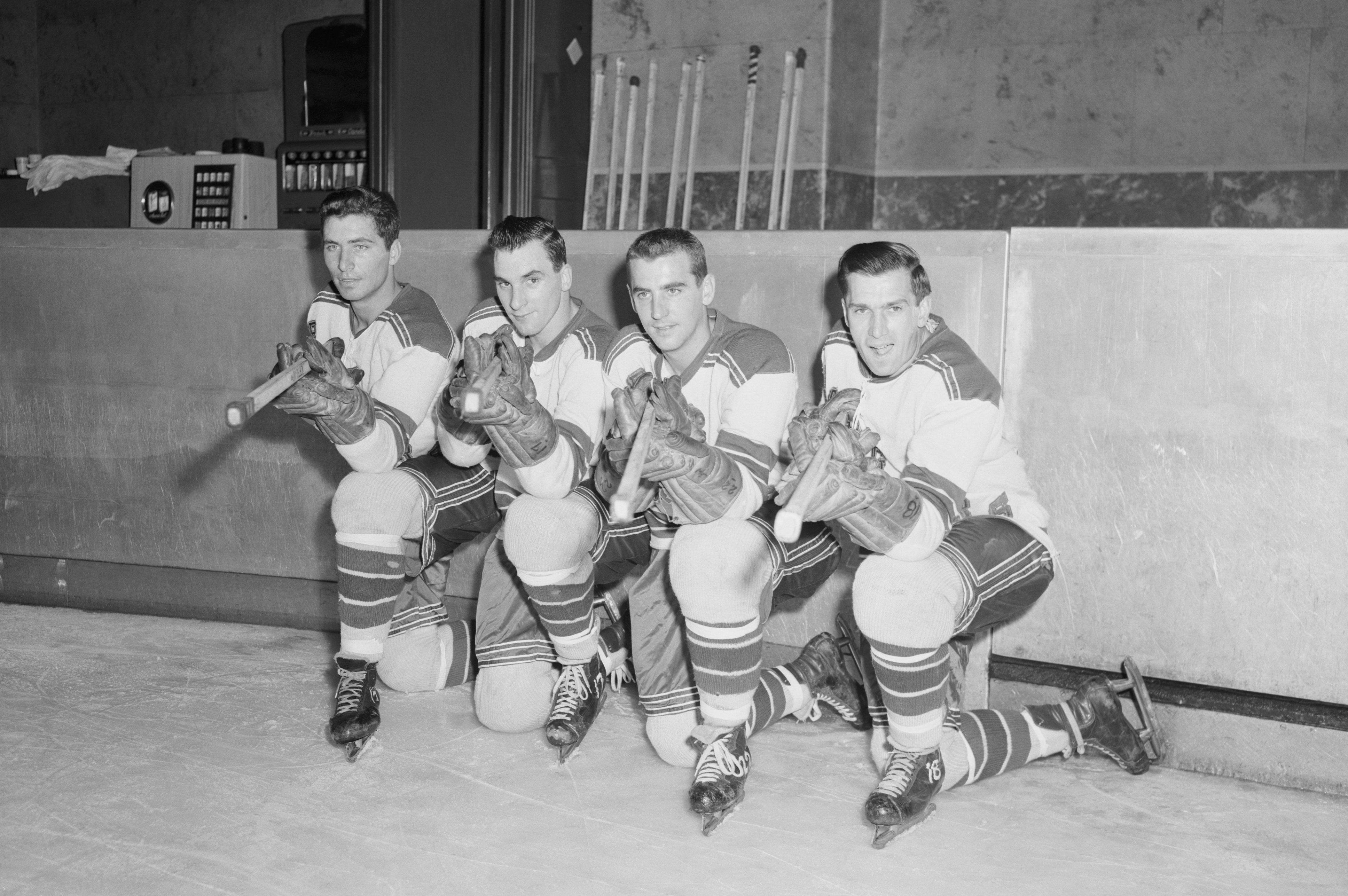 Here are the four sharpshooters of the New York Rangers who are expected to score 100 goals for the season as they paused during a workout at Madison Square Garden today. From left: Andy Bathgate, Dean Prentice, Danny Lewicki, and Wally Hergesheimer. The Rangers show every sign of going to town this year. The won their NHL opener for the first time in eight years at Chicago and licked the Detroit Red Wings for the first time since the 1953-54 season.