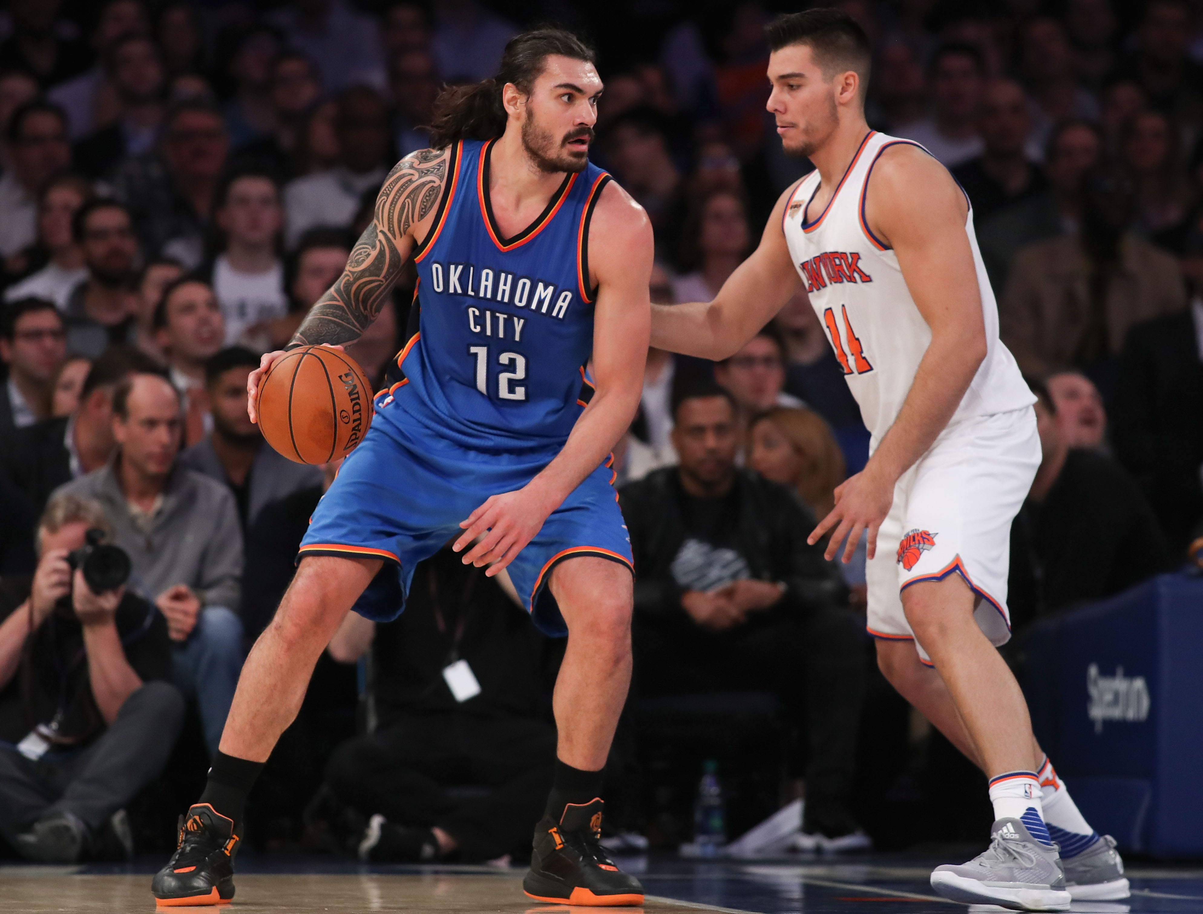 NEW YORK, NY - NOVEMBER 28: Steven Adams #12 of the Oklahoma City Thunder drives to the basket defended by Willy Hernangomez #14 of the New York Knicks during the second half at Madison Square Garden on November 28, 2016 in New York City. NOTE TO USER: User expressly acknowledges and agrees that, by downloading and or using this photograph, User is consenting to the terms and conditions of the Getty Images License Agreement. (Photo by Michael Reaves/Getty Images)