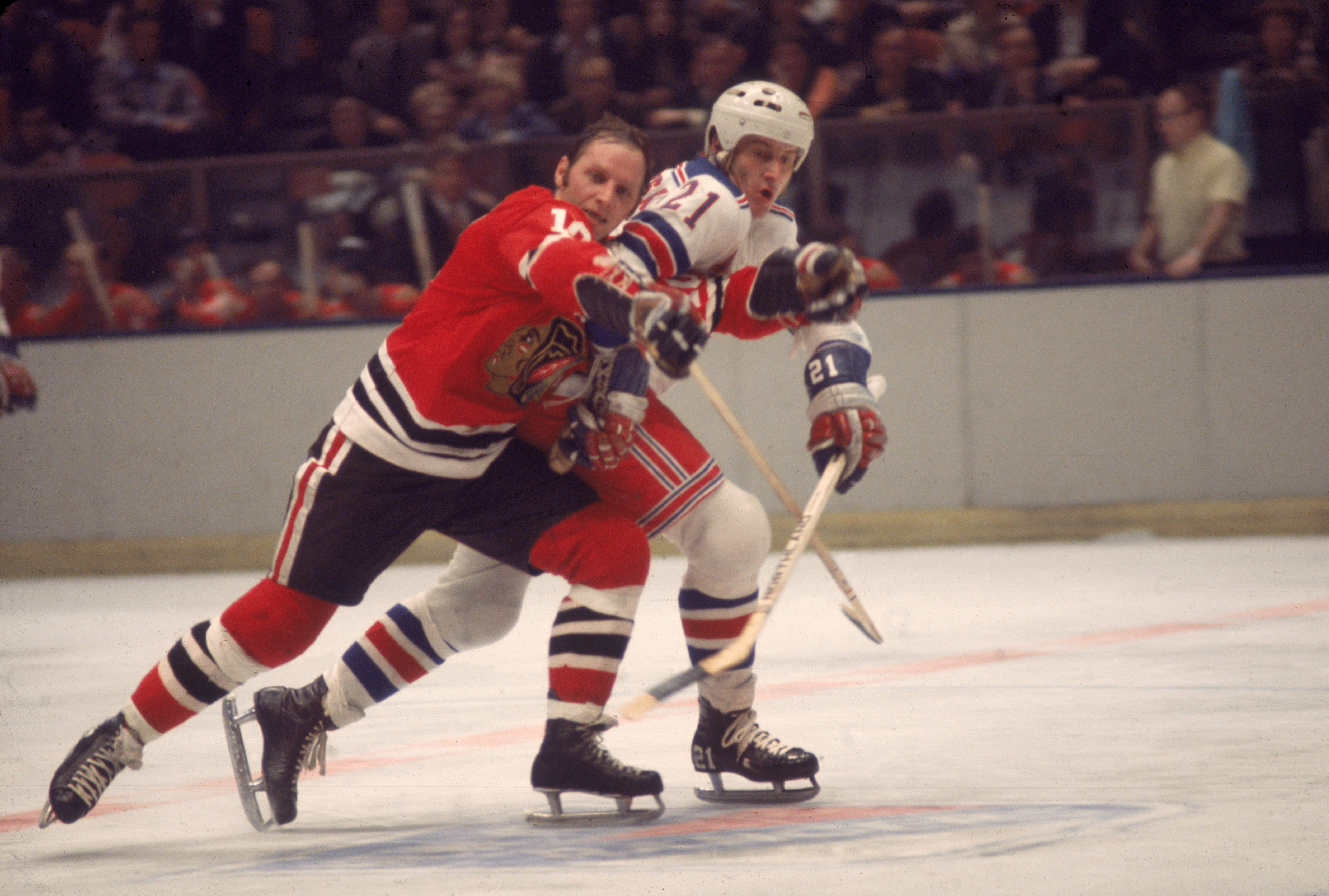 Canadian professional ice hockey player Pete Stemkowski #21 (right) of the New York Rangers checks opponent Dennis Hull #10 of the Chicago Blackhawks as they struggle on the ice during a game at Madison Square Garden, New York, 1970s. Stemkowski played for the Rangers from 1971 to 1977. (Photo by Melchior DiGiacomo/Getty Images)